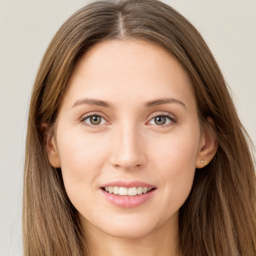 Joyful white young-adult female with long  brown hair and grey eyes