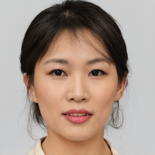 Joyful asian young-adult female with medium  brown hair and brown eyes