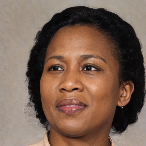 Joyful black adult female with medium  black hair and brown eyes