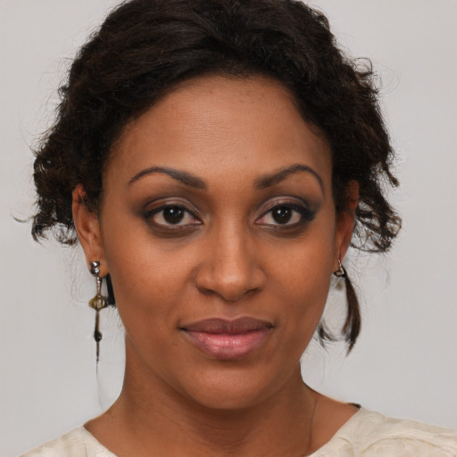 Joyful black young-adult female with medium  brown hair and brown eyes