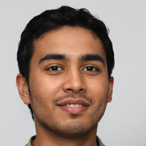 Joyful latino young-adult male with short  black hair and brown eyes