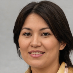 Joyful asian adult female with medium  brown hair and brown eyes