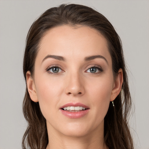 Joyful white young-adult female with long  brown hair and grey eyes