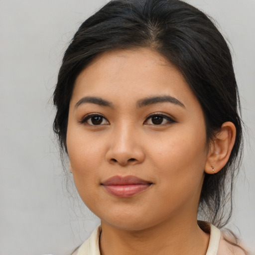 Joyful asian young-adult female with medium  brown hair and brown eyes