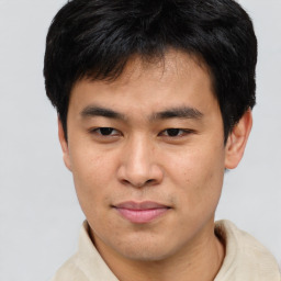 Joyful asian young-adult male with short  brown hair and brown eyes