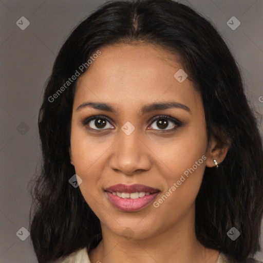 Joyful black young-adult female with long  brown hair and brown eyes