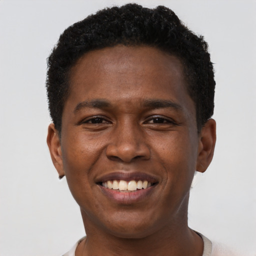 Joyful black young-adult male with short  brown hair and brown eyes