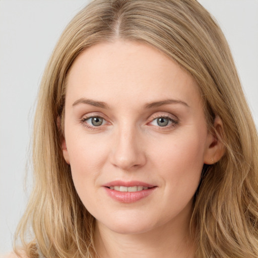 Joyful white young-adult female with long  brown hair and blue eyes