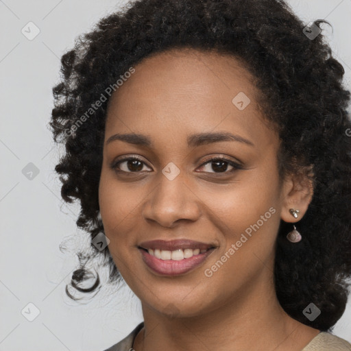 Joyful black young-adult female with long  black hair and brown eyes