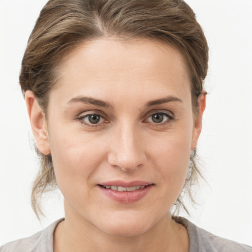 Joyful white young-adult female with medium  brown hair and grey eyes