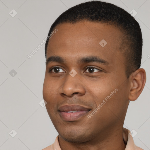 Joyful black young-adult male with short  black hair and brown eyes