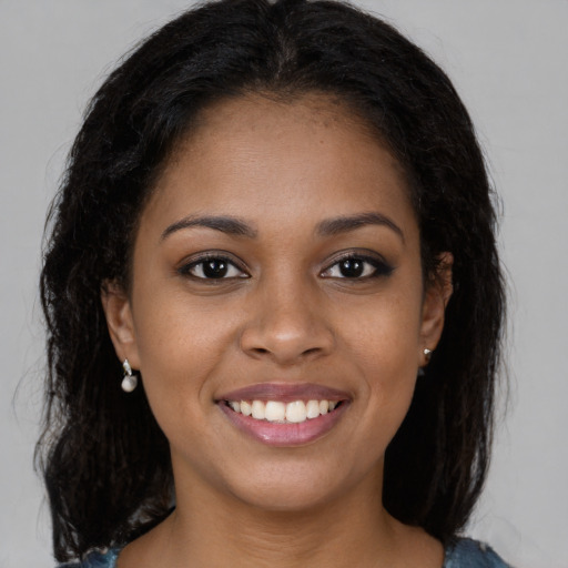 Joyful black young-adult female with medium  brown hair and brown eyes