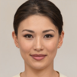 Joyful asian young-adult female with short  brown hair and brown eyes