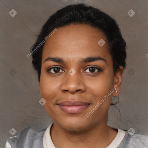 Joyful black young-adult female with short  black hair and brown eyes