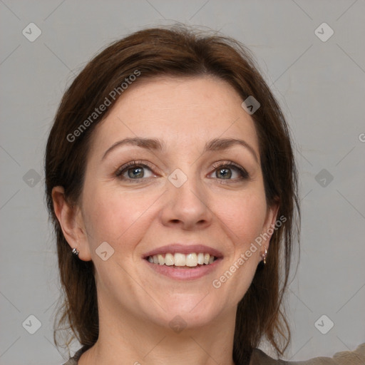 Joyful white adult female with medium  brown hair and grey eyes