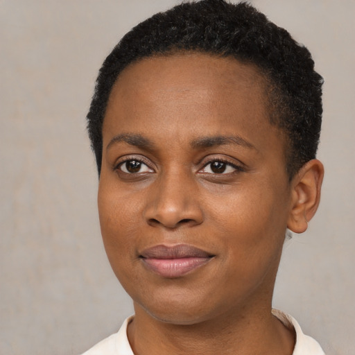 Joyful black young-adult female with short  brown hair and brown eyes