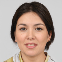 Joyful white young-adult female with medium  brown hair and brown eyes