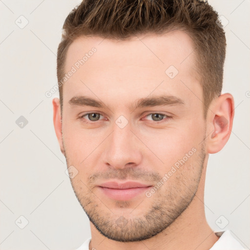 Joyful white young-adult male with short  brown hair and brown eyes