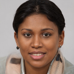 Joyful latino young-adult female with medium  brown hair and brown eyes