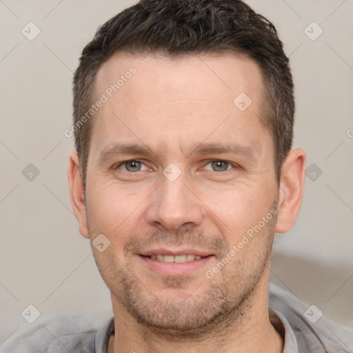 Joyful white adult male with short  brown hair and brown eyes