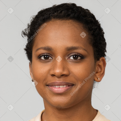 Joyful black young-adult female with short  brown hair and brown eyes