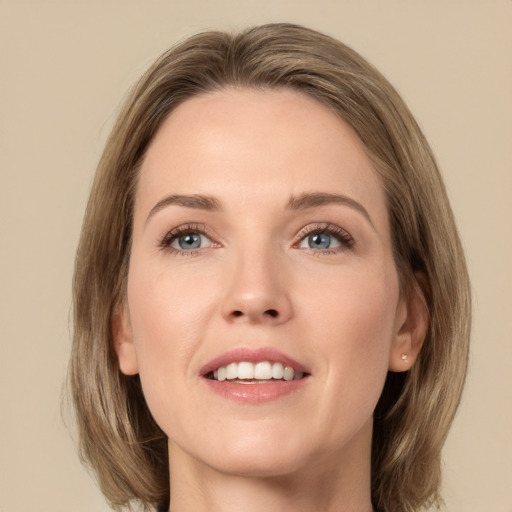 Joyful white young-adult female with medium  brown hair and grey eyes