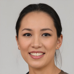 Joyful asian young-adult female with medium  brown hair and brown eyes