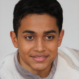 Joyful latino young-adult male with short  brown hair and brown eyes