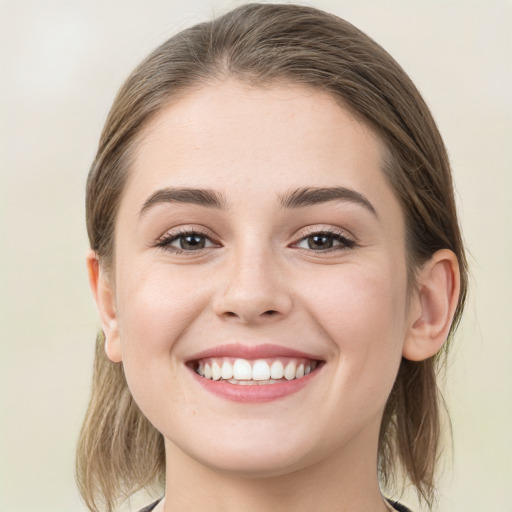 Joyful white young-adult female with medium  brown hair and blue eyes