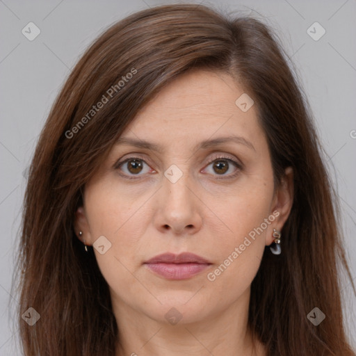 Joyful white adult female with long  brown hair and brown eyes