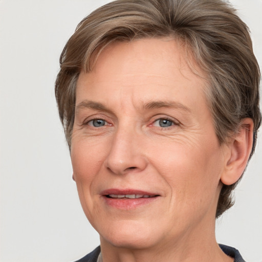 Joyful white adult female with short  brown hair and grey eyes