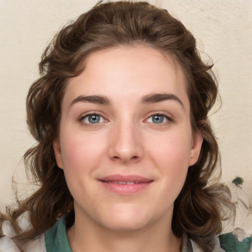 Joyful white young-adult female with medium  brown hair and green eyes