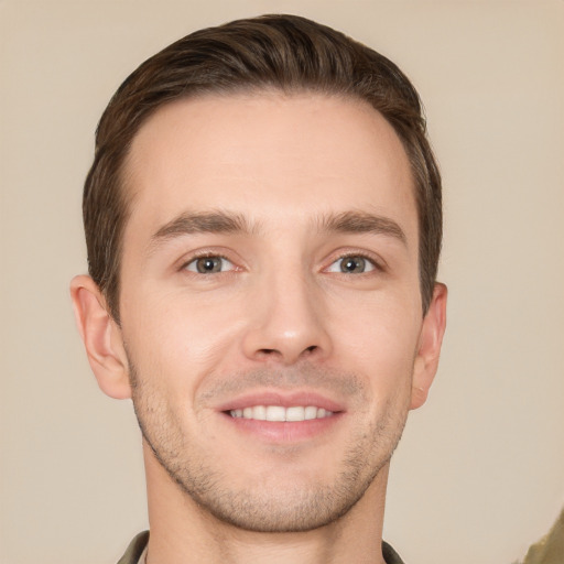 Joyful white young-adult male with short  brown hair and brown eyes