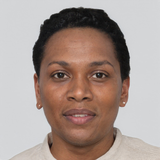Joyful black adult female with short  black hair and brown eyes