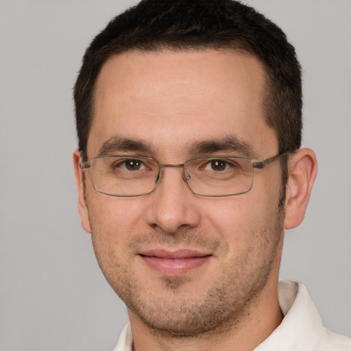 Joyful white adult male with short  brown hair and brown eyes