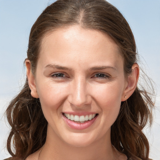 Joyful white young-adult female with long  brown hair and grey eyes