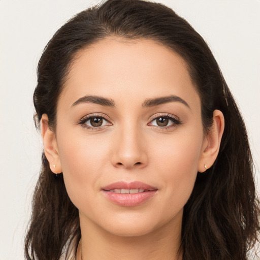 Joyful white young-adult female with long  brown hair and brown eyes