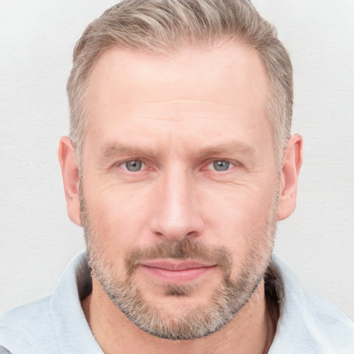 Joyful white adult male with short  brown hair and grey eyes