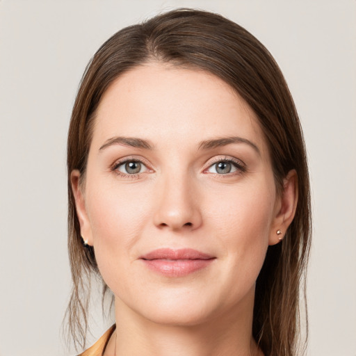 Joyful white young-adult female with long  brown hair and grey eyes