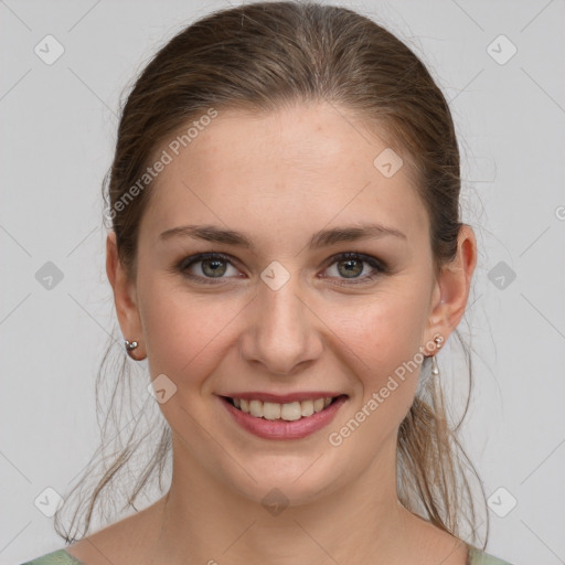 Joyful white young-adult female with medium  brown hair and grey eyes