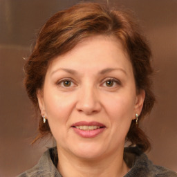 Joyful white adult female with medium  brown hair and brown eyes