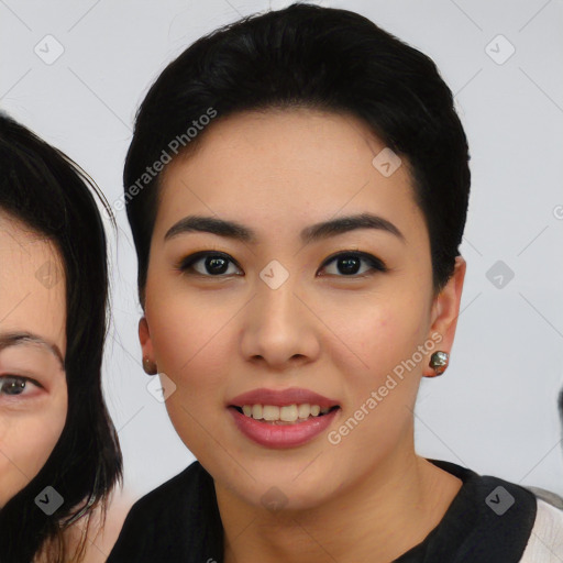 Joyful asian young-adult female with medium  black hair and brown eyes