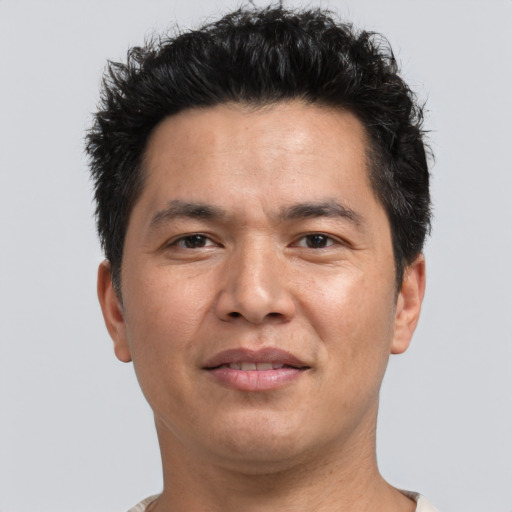 Joyful asian adult male with short  brown hair and brown eyes