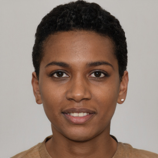 Joyful black young-adult female with short  black hair and brown eyes