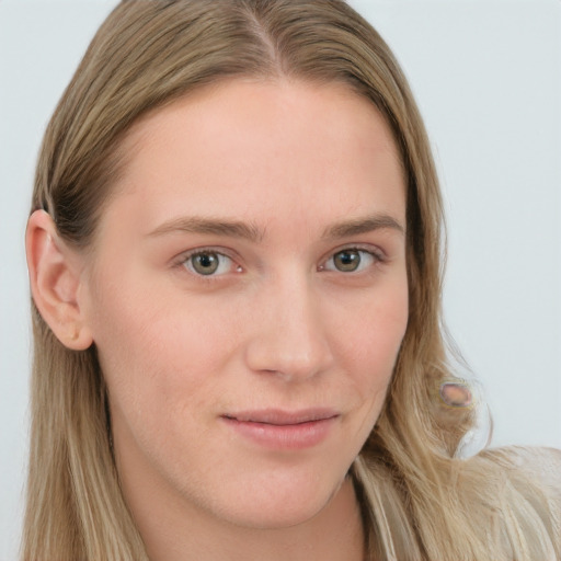 Joyful white young-adult female with long  brown hair and blue eyes