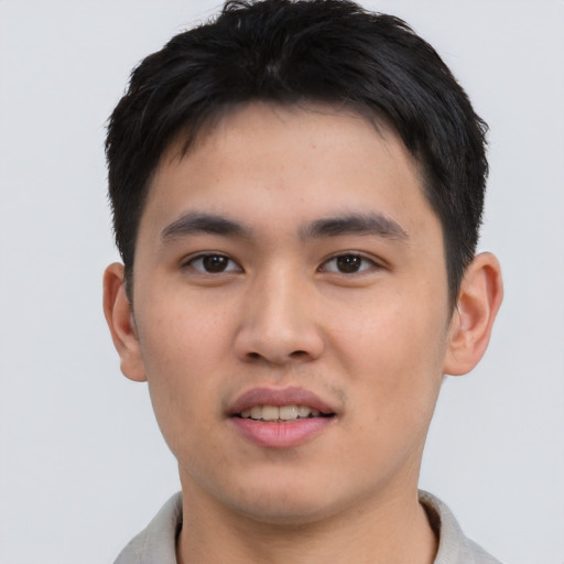 Joyful asian young-adult male with short  brown hair and brown eyes