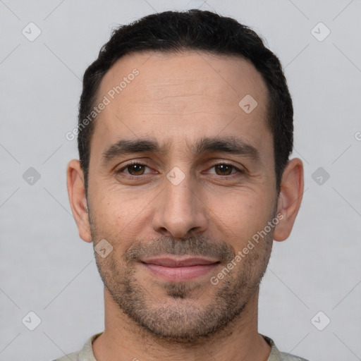 Joyful white young-adult male with short  black hair and brown eyes