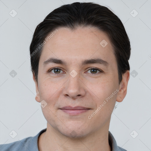 Joyful white young-adult male with short  black hair and brown eyes