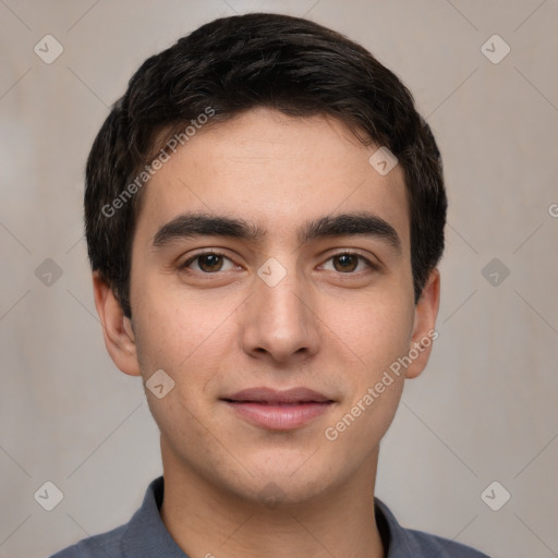 Joyful white young-adult male with short  black hair and brown eyes