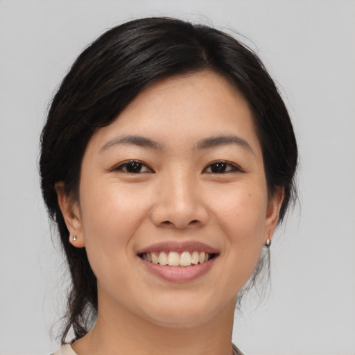 Joyful asian young-adult female with medium  black hair and brown eyes